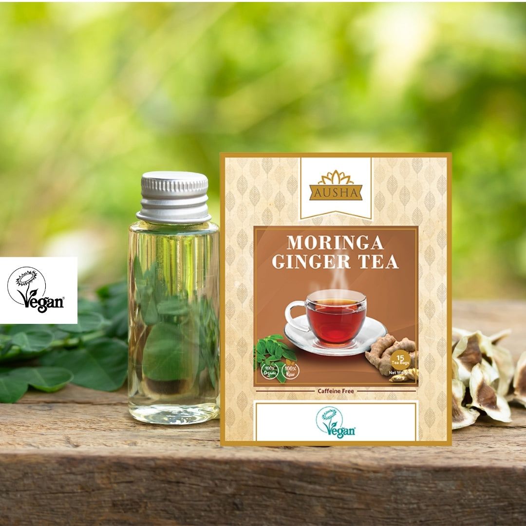 Moringa Ginger Tea box with herbal infusion ingredients on a wooden surface.