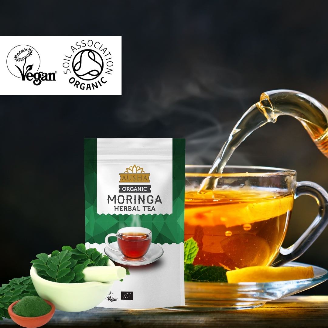 Organic Moringa Tea 100g package with a glass cup being filled, vegan and organic certification logos.
