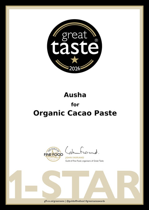 A certificate-style graphic for Ausha Organic Cacao Paste, featuring a black circular 'great taste 2026' badge at the top, product text in the center, a Fine Food Award logo near the bottom, and a large '1-STAR' watermark across the lower portion on a white background with a thin black border.