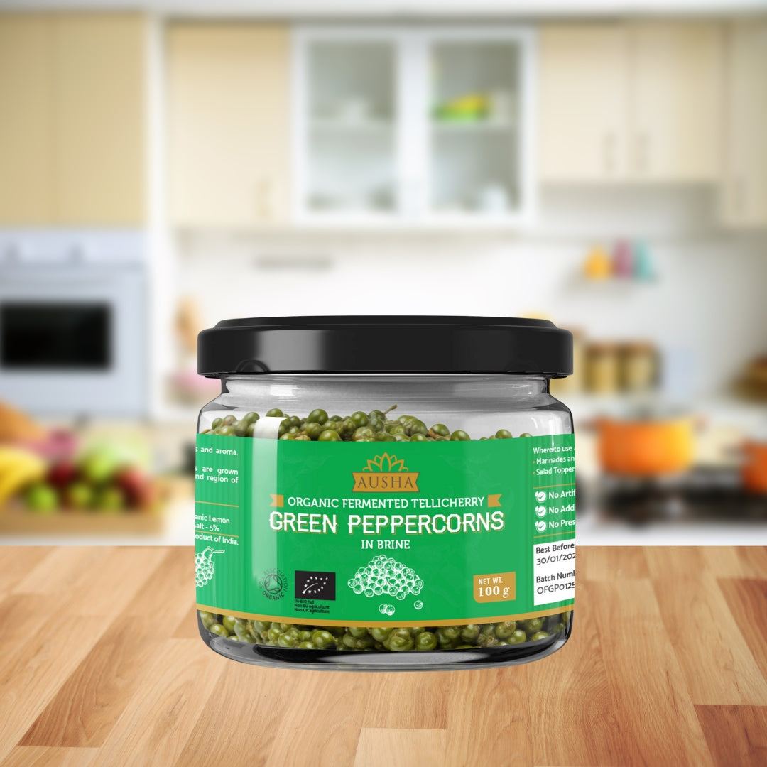 Organic green peppercorns in brine 100g jar on kitchen counter.