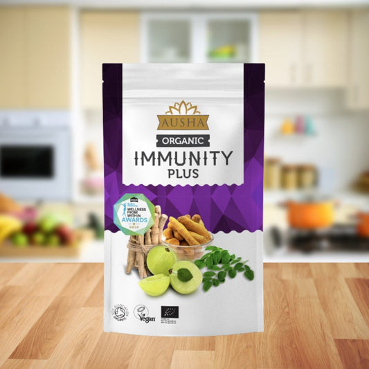 Organic Immunity Plus Superfood Powder packaging in kitchen setting.