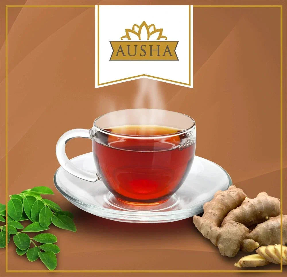 Moringa Ginger Tea in a glass cup with moringa leaves and ginger root.