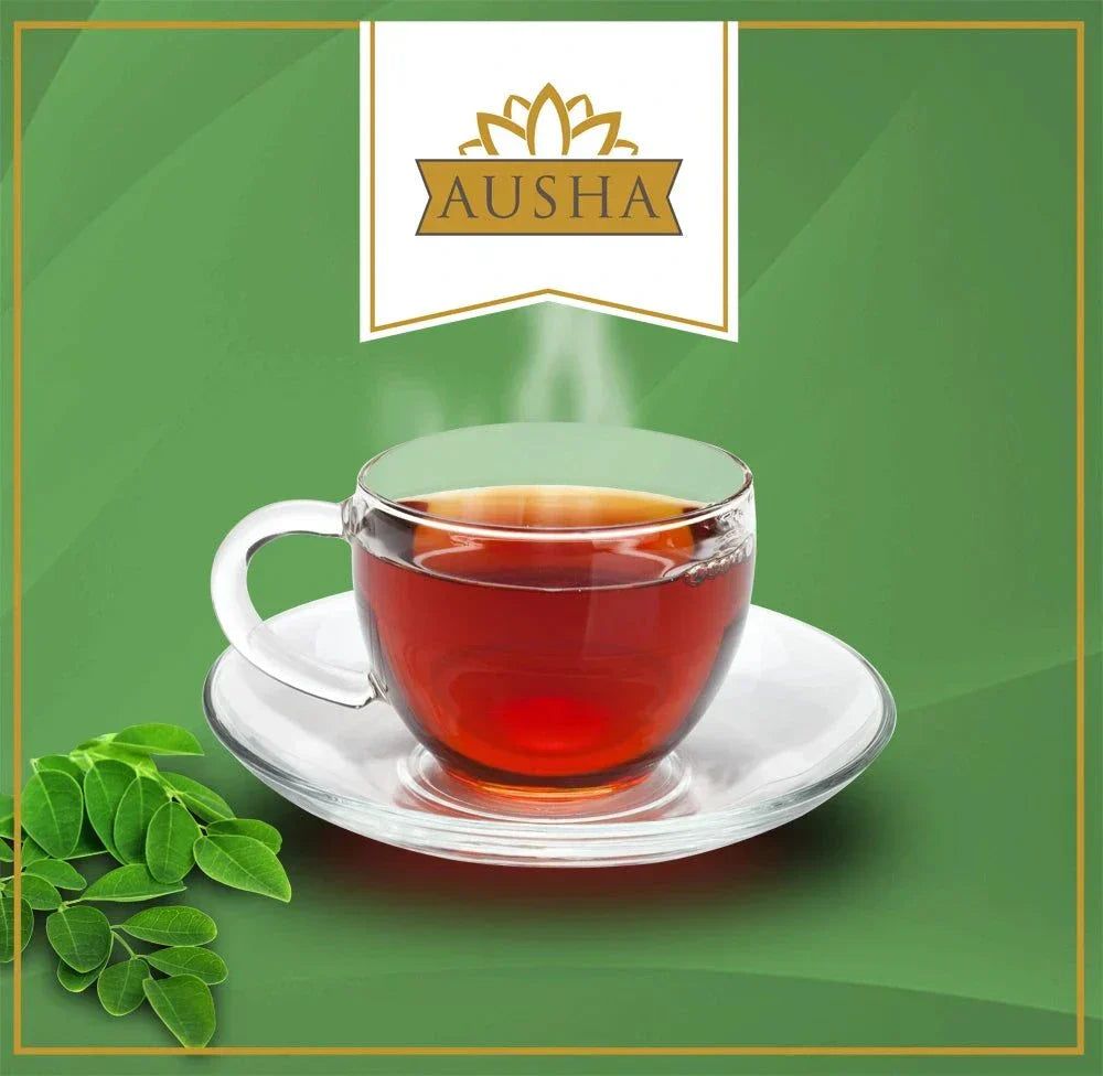 Organic Moringa Tea in a clear cup on a saucer, with fresh moringa leaves on a green background.