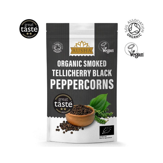 Organic Smoked Telicherry Black Peppercorns 100g package with vegan and organic certifications, featuring rich, smoky aroma ideal for BBQ and grilled dishes.