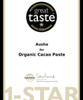 A certificate-style graphic for Ausha Organic Cacao Paste, featuring a black circular 'great taste 2026' badge at the top, product text in the center, a Fine Food Award logo near the bottom, and a large '1-STAR' watermark across the lower portion on a white background with a thin black border.