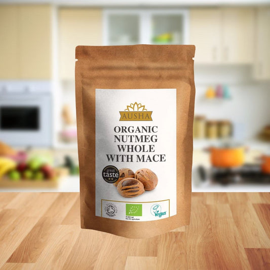 Organic nutmeg with whole mace in a 50g package on a kitchen counter, featuring warm, sweet, and slightly nutty flavors.